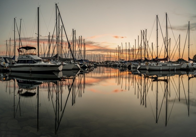 A new day starts as the boats rest during sunrise