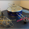 24 Giant Metal Paper Clips and a Tin of Butter Biscuits