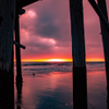 Sunset under Newport pier glowing