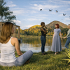 Women conversing by a peaceful lake