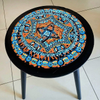 Living room table with artwork pasted on it by Mirit Ben-Nun