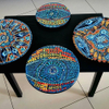 Living room table with artwork pasted on it by Mirit Ben-Nun